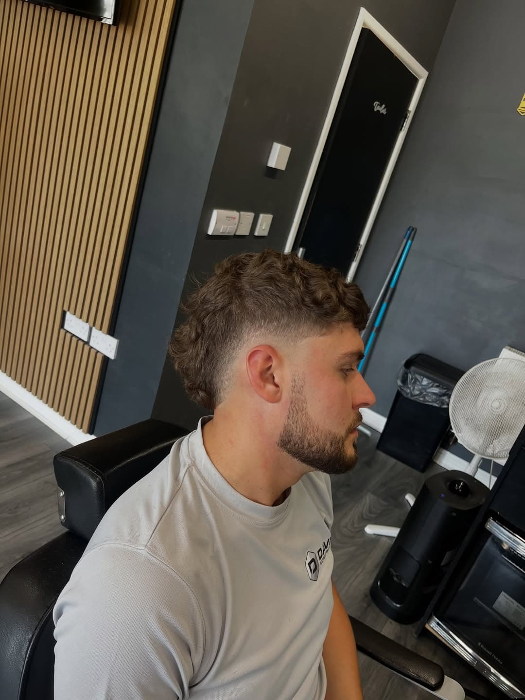 Finished curly burst fade, profile in the studio