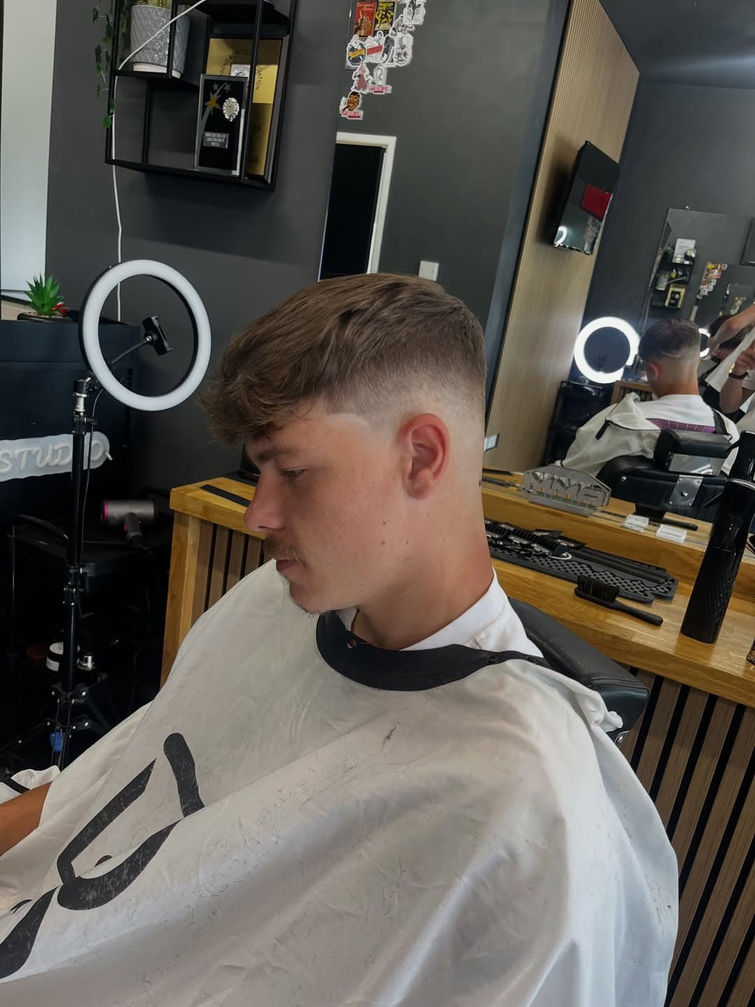 Skin fade with clippers on the wooden station